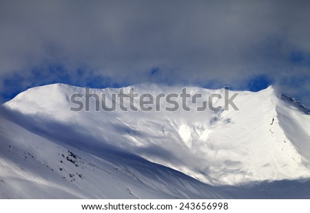 View on sunlight off-piste slope in mist. Caucasus Mountains, Georgia, ski resort Gudauri.