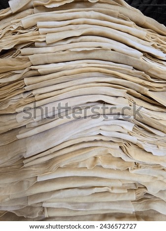 A warehouse full of rubber sheets ready to be sent for production. A raw rubber latex flat to dry. Rubber sheet is a raw material for many industrial product. Royalty-Free Stock Photo #2436572727