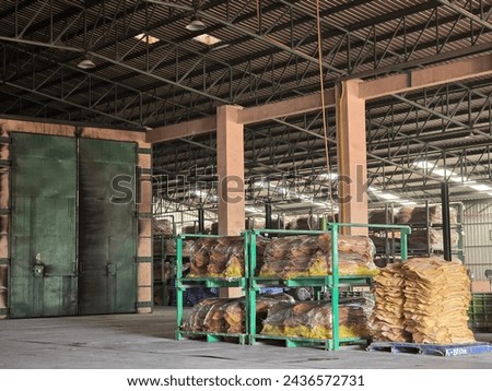 A warehouse full of rubber sheets ready to be sent for production. A raw rubber latex flat to dry. Rubber sheet is a raw material for many industrial product. Royalty-Free Stock Photo #2436572731