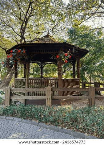 A wooden pavilion perfect for relax and rest after walks around the garden in Kobe, Japan Royalty-Free Stock Photo #2436574775