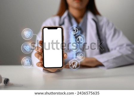 Female doctor showing smartphone with medical icons. Telemedicine Concept