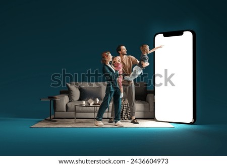 Family interacting with huge 3D model of smartphone in living room against blue background. Online shopping, delivery services, sales. Modern technologies. Mockup for ad, text, design, logo