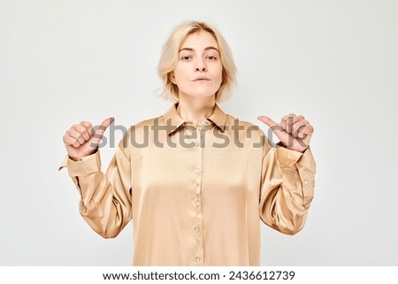 Woman pointing fingers at herself, giving thumbs up, isolated on white background.