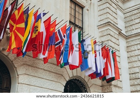 National flags of various countries flying in the wind. Colorful flags from different countries. Flags Organization for Security and Co-operation in Europe Royalty-Free Stock Photo #2436621815