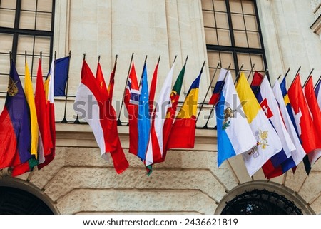 National flags of various countries flying in the wind. Colorful flags from different countries. Flags Organization for Security and Co-operation in Europe Royalty-Free Stock Photo #2436621819
