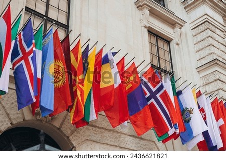 National flags of various countries flying in the wind. Colorful flags from different countries. Flags Organization for Security and Co-operation in Europe Royalty-Free Stock Photo #2436621821