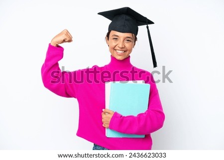 Young student hispanic woman holding a books isolated on white background doing strong gesture