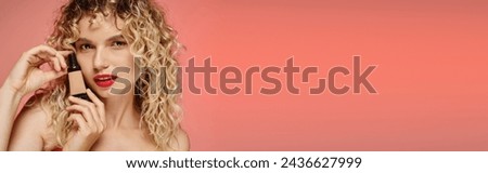 attractive woman with red lips and wavy hair showing makeup foundation on pink backdrop, banner