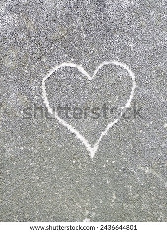 Love and heart symbol on cement wall.