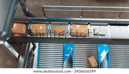 Recyclable Cardboard Box Being Transported on a Conveyor Belt in a Modern Logistics Center. Parcel is Prepared for Delivery to an Online Client. Rendered Conveyor System of a Big Retail Business Royalty-Free Stock Photo #2436656399