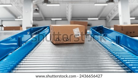 Autonomous Conveyor Belt Sorting Mechanism with Artificial Intelligence Capabilities Handling, Sorting and Preparing Parcels for Delivery to Online Clients in a Modern Logistics Warehouse Royalty-Free Stock Photo #2436656427