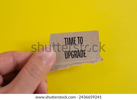 Time to upgrade words written on torn paper piece with yellow background. Conceptual symbol. Copy space.