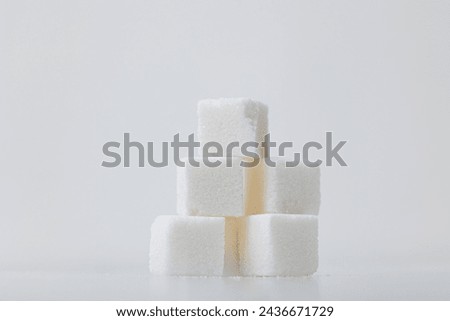 Sugar cubes stacked neatly on a white background Royalty-Free Stock Photo #2436671729
