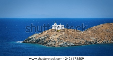 Aerial view of the lighthouse and Agios Nikolaos Church entering the port of Tzia, Kea island, Cyclades, Greece Royalty-Free Stock Photo #2436678509