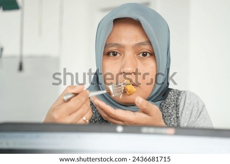 A female model is eating in a cafe