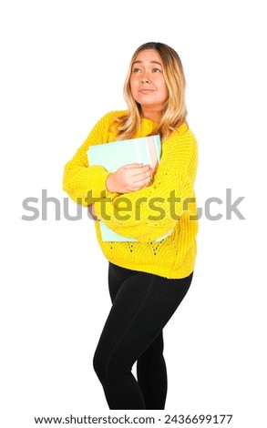 Unhappy young blonde female teacher holding different folders against a white background