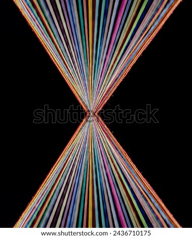 Converging Rainbow Colored Threads on dark background Royalty-Free Stock Photo #2436710175