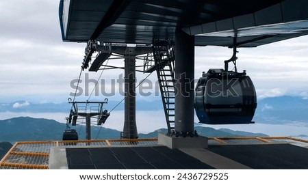 Ropeway, cable car cabins against seascape in Oludeniz, Turkey. Tourism, cableway, sightseeing concept. Cableway system at Babadag Peak. High quality photo Royalty-Free Stock Photo #2436729525