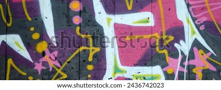 Colorful background of graffiti painting artwork with bright aerosol outlines on wall. Old school street art piece made with aerosol spray paint cans. Contemporary youth culture backdrop Royalty-Free Stock Photo #2436742023