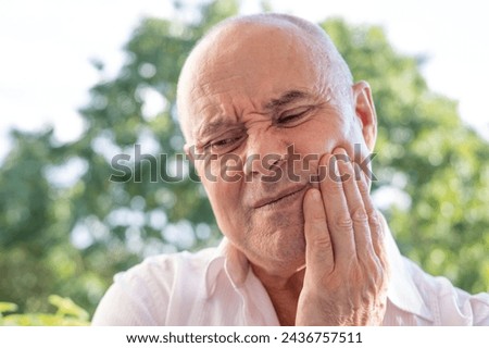 senior, caucasian man holds on to jaw, close up male face with facial expression suffering, unbearable tooth pain, toothache, dental pain, oral discomfort, throbbing tooth pain Royalty-Free Stock Photo #2436757511