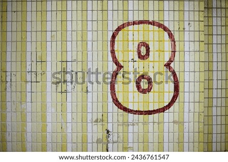 handwritten number 8 on a tiled old wall Royalty-Free Stock Photo #2436761547