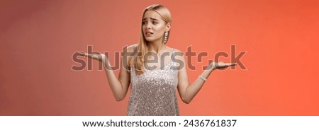 Lifestyle. Anxious insecure young cute blond girl feel lost unsure shrugging hands sideways weighing decisions look right seek help standing lost nervous hesitating red background in silver glittering