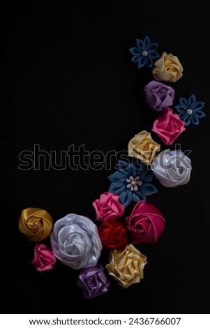 composition of vintage homemade flowers on a black background