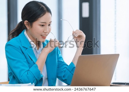 Asian businesswoman working on digital laptop computer at table office. Technology and digital marketing online concept.
