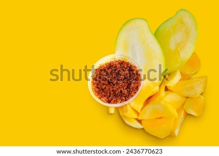Mango, cut into bite-sized pieces yellow background , ready to eat. Ready to serve with dipping sauce, chili and salt, Thai style, Asian food. Royalty-Free Stock Photo #2436770623