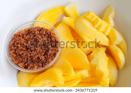 Mango, cut into bite-sized pieces, ready to eat. serve with dipping sauce, chili and salt, Thai style, Asian food. Royalty-Free Stock Photo #2436771319