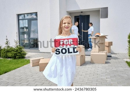 Girl stands in the courtyard of country house with signs