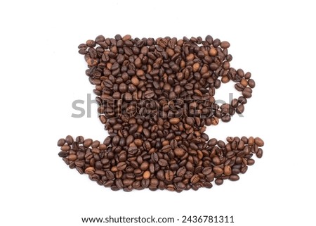 A pile of coffee beans in the shape of a coffee cup, on a white background. Top view