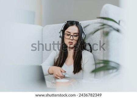 Woman strategizing growth and analyzing stats in cozy workplace. Experienced businesswoman leads successful project development and profit growth. Royalty-Free Stock Photo #2436782349