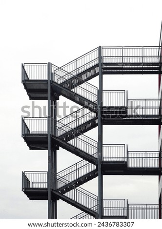 external safety and emergency metal staircase, black and white photo
