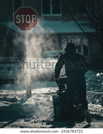 A man showelling snow off sidewalk