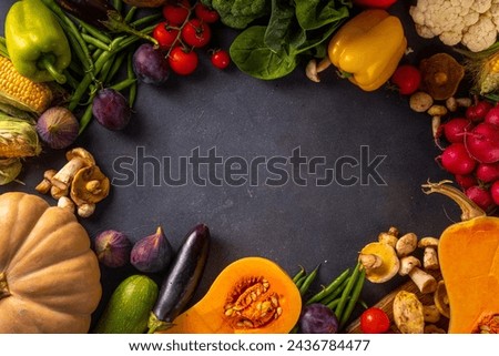 Autumn vegetable preparation dinner background. Food background with organic fresh farm raw veggies, pumpkin, corn, fruits, mushrooms, salad leaves, greenery, Ingredients for cooking with copy space.