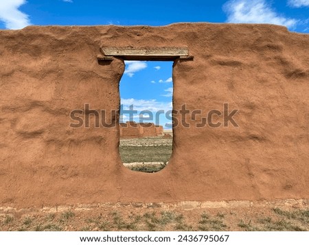 Fort Union National Monument in New Mexico. Preserves fort's adobe ruins along Santa Fe Trail. Window in adobe wall.  Royalty-Free Stock Photo #2436795067