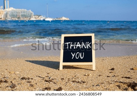 Thank you symbol. Concept word Thank you on black chalk background. Beautiful sea background. Business and Thank you concept. Copy space.