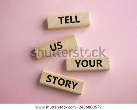 Tell us your story symbol. Concept words Tell us your story on wooden blocks. Beautiful pink background. Business and Tell us your story concept. Copy space.