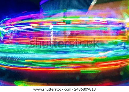 Colorful lights in long exposure of a fair game