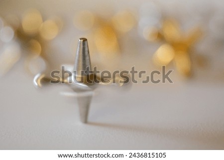 spinning silver jack with gold jacks in background Royalty-Free Stock Photo #2436815105