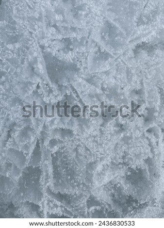 Winter ice background. Snowy iced texture, close up of ice block in nature Royalty-Free Stock Photo #2436830533