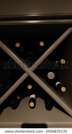 Close up of a white and black wine cabinet with bottles, low angle view, editorial photography, professional color grading, soft shadows, no contrast, clean sharp focus, magazine style photography 