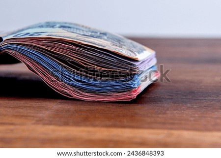 Hungarian HUF banknotes, pile of money on a brown table