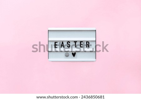 Lightbox with text Easter on pink background. Concept Easter style. Creative composition Flat lay.  Greeting card. Top view. Happy Easter led sign. 