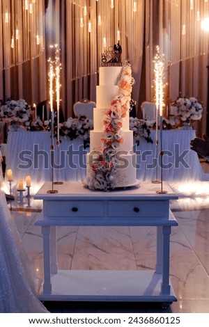 A picture of close up a wedding party cake with firework
