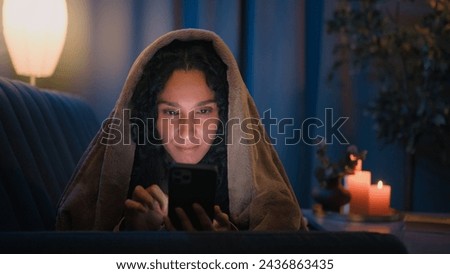 Hispanic Arabian girl Latino woman Indian addicted female at night home in bed under blanket cover with duvet looking mobile phone scrolling browsing social media smartphone influencer gadget addict Royalty-Free Stock Photo #2436863435