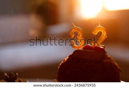 Birthday Candle is 32 on sunset background