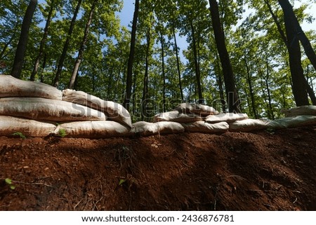 a military unit strategically employs sandbags as a defensive wall, creating a fortified barrier to enhance their safety and protection, showcasing the tactical use of simple yet effective measures