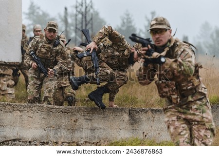 A highly trained elite military unit, clad in camouflage, skillfully navigates through perilous forest terrain, overcoming obstacles and executing a precise and covert mission Royalty-Free Stock Photo #2436876863